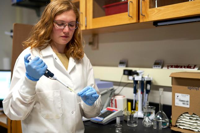 希瑟·里克，火博体育学院的一名学生，在化学实验室里将氮气滴入试管中